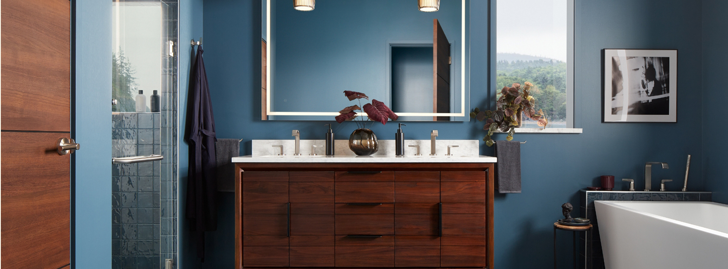 Blue bathroom with a teak vanity in the center.
