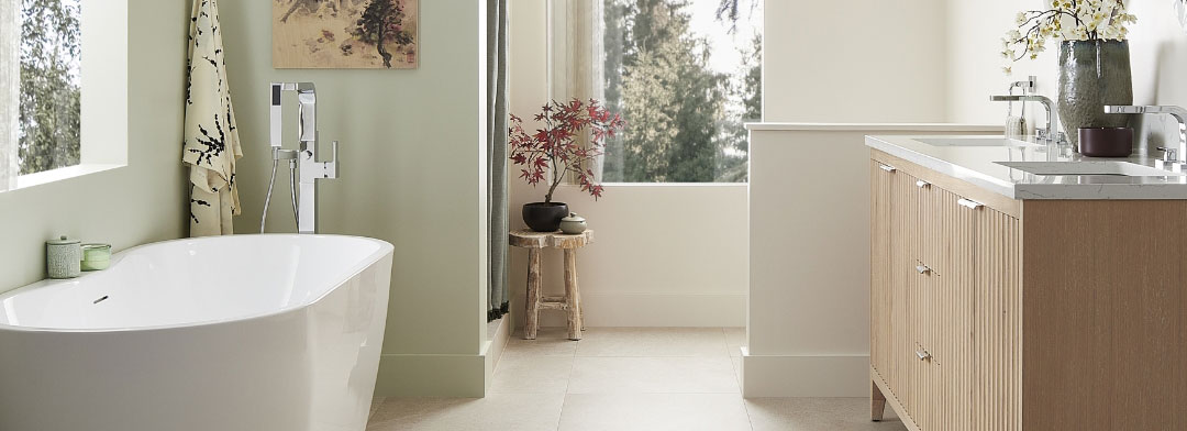Zen style bathroom with a wood vanity on right and a bathtub on the left.